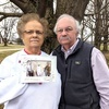 Mimi and Billy Glenn Turpin show off a photo of their 50th wedding anniversary in 2009. The dress in the picture is one Mimi wore in 1969. During the 1974 tornado, the dress was tossed into a pond roughly 100 yards from their house in northern Madison County.